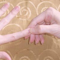 Hand reflexology: pinching fingertips.